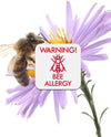 Bee on a flower with bee allergy sticker