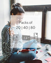 Young woman writing letters to friends with return address labels