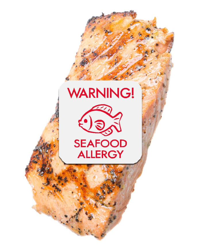Piece of barbecued salmon with seafood allergy sticker